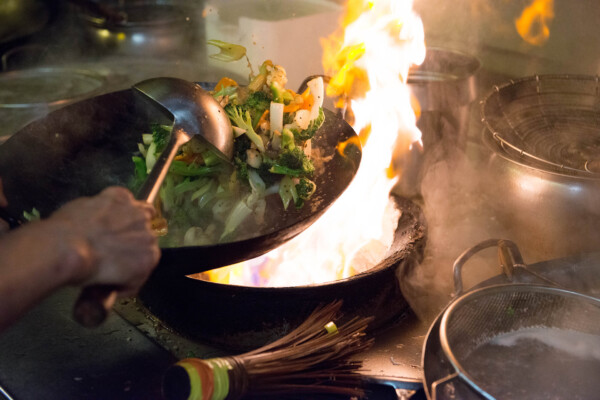 sautéing vegetables in a wok
